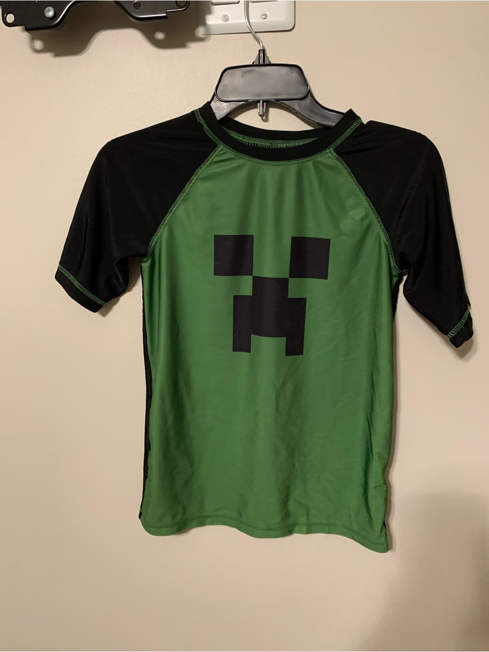 Green & Black Kids' One-Piece Swim Shirt with Pixel Face Graphic. Size L